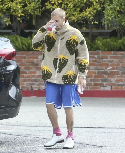 Justin Bieber was spotted wearing a strawberry-themed outfit, holding a red berry blackcurrant tea, and pairing it all with berry-colored socks.