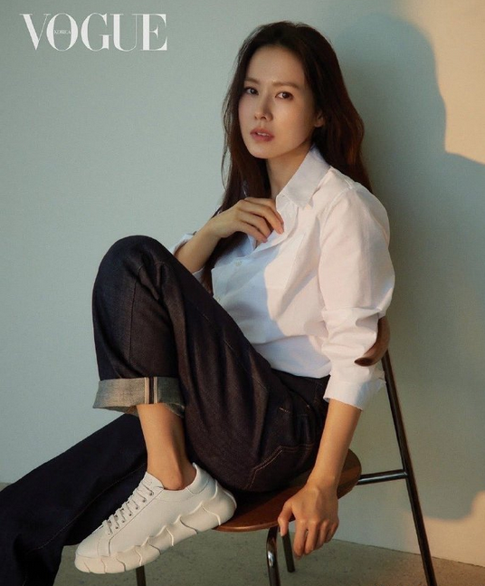 Son Ye-jin graces the latest issue of Korean Vogue in a fresh and youthful look: a white shirt, jeans, and canvas sneakers.