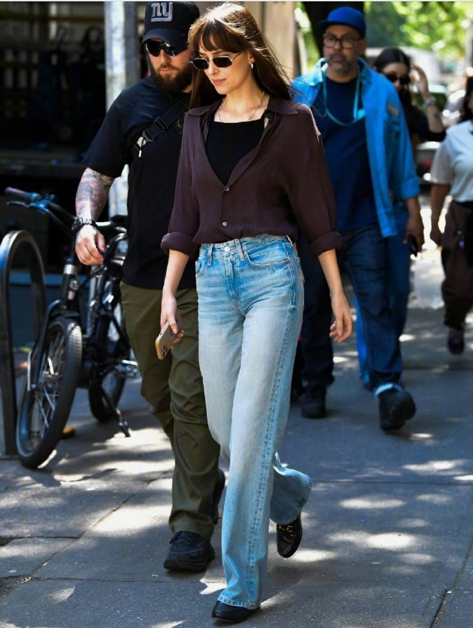 Dakota Johnson in silk blouse & high-waisted jeans