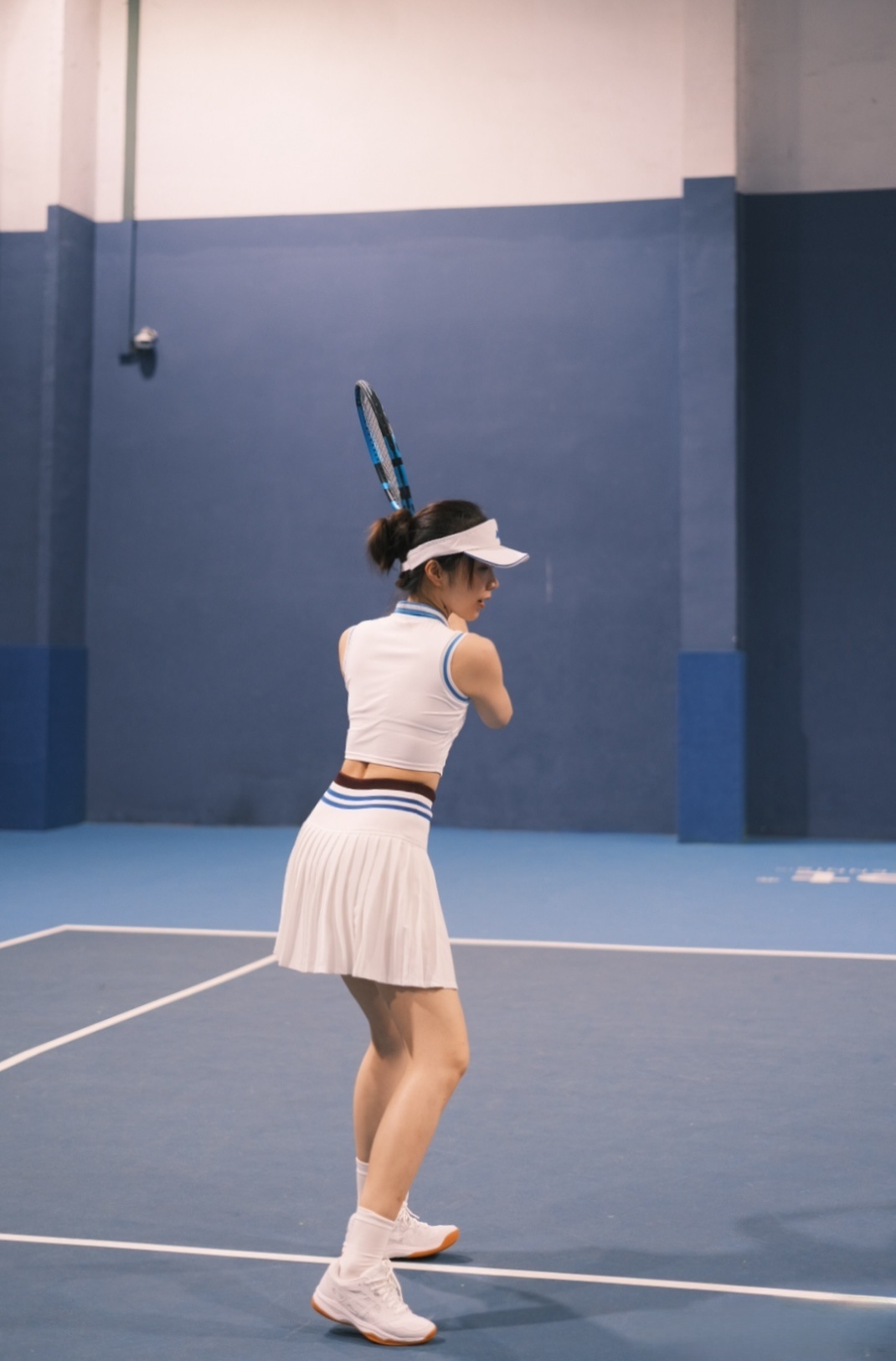 Tennis outfit: white sleeveless top and pleated skirt