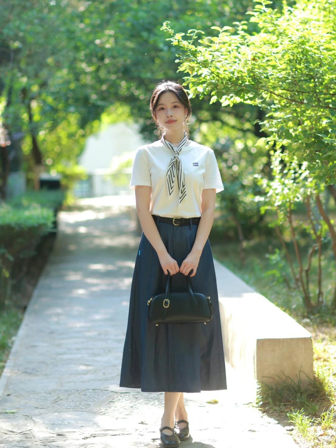 White short-sleeve T-shirt paired with a denim A-line skirt