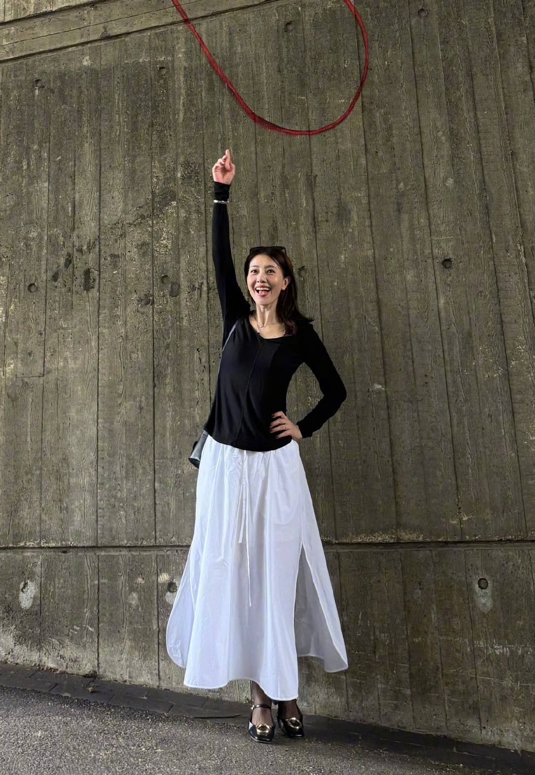 Gao Yuanyuan in black long-sleeve top with white slit maxi skirt