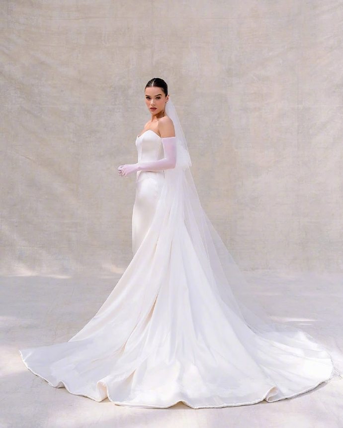 Hailee Steinfeld wearing a pure white wedding dress.
