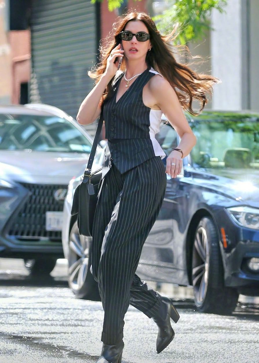 Anne Hathaway wears pinstripe trousers on the set of The Devil Wears Prada 2