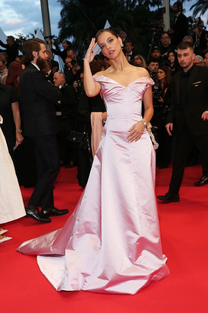 Barbara Palvin stuns on the Cannes red carpet in a shimmering satin pink gown.