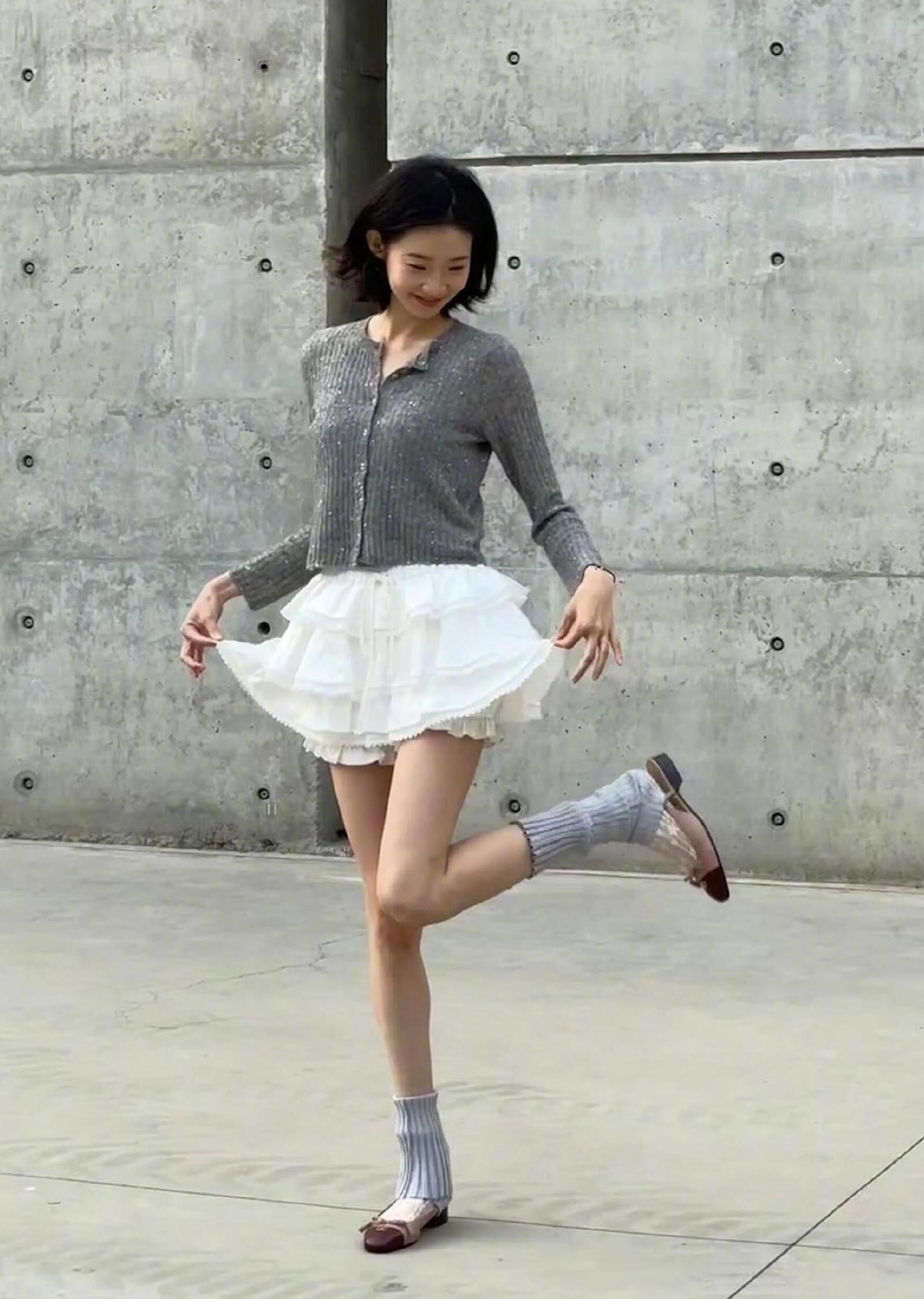 Sweet girl look with a grey buttoned cardigan and a white mini skirt.