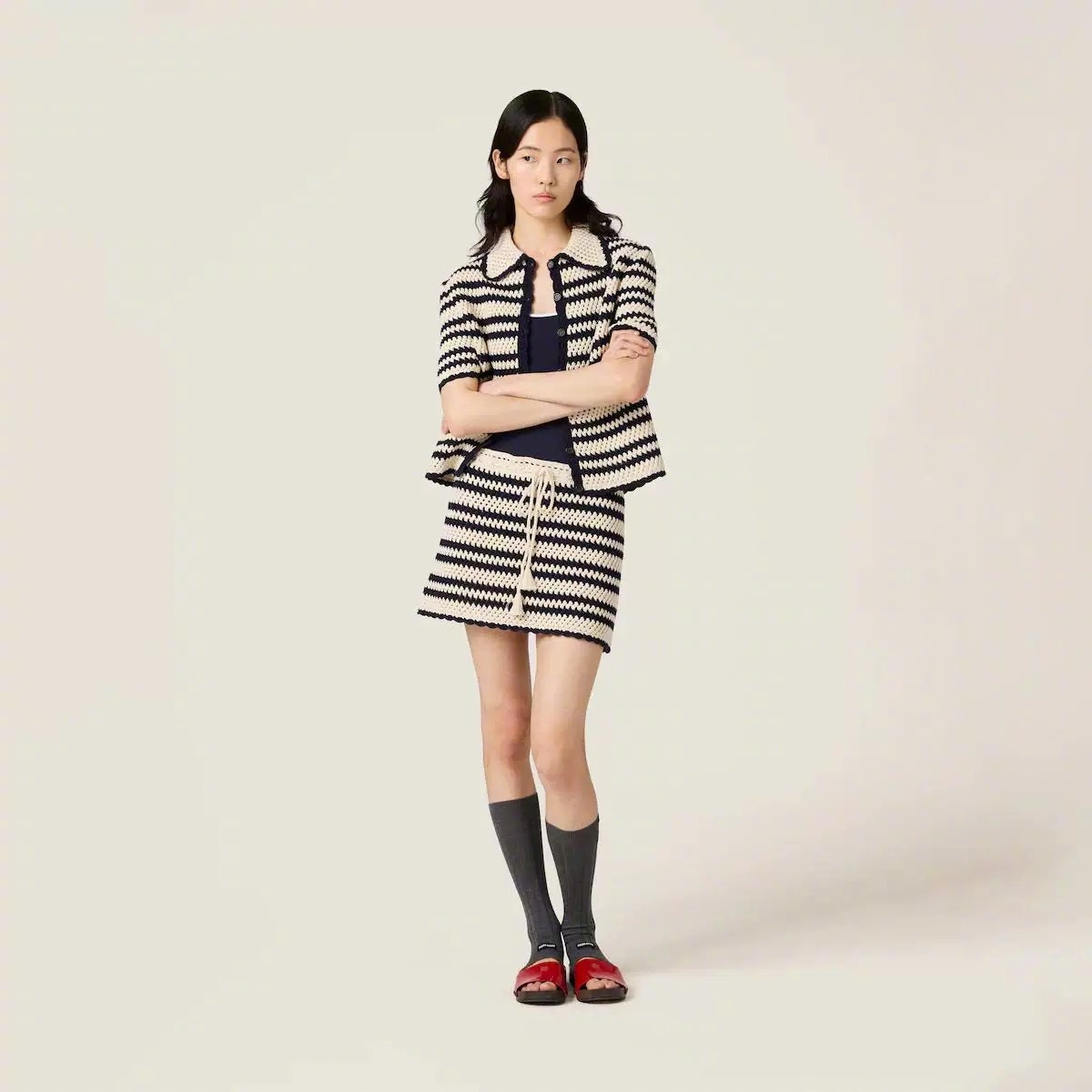 Knit short-sleeve jacket and paired mini skirt