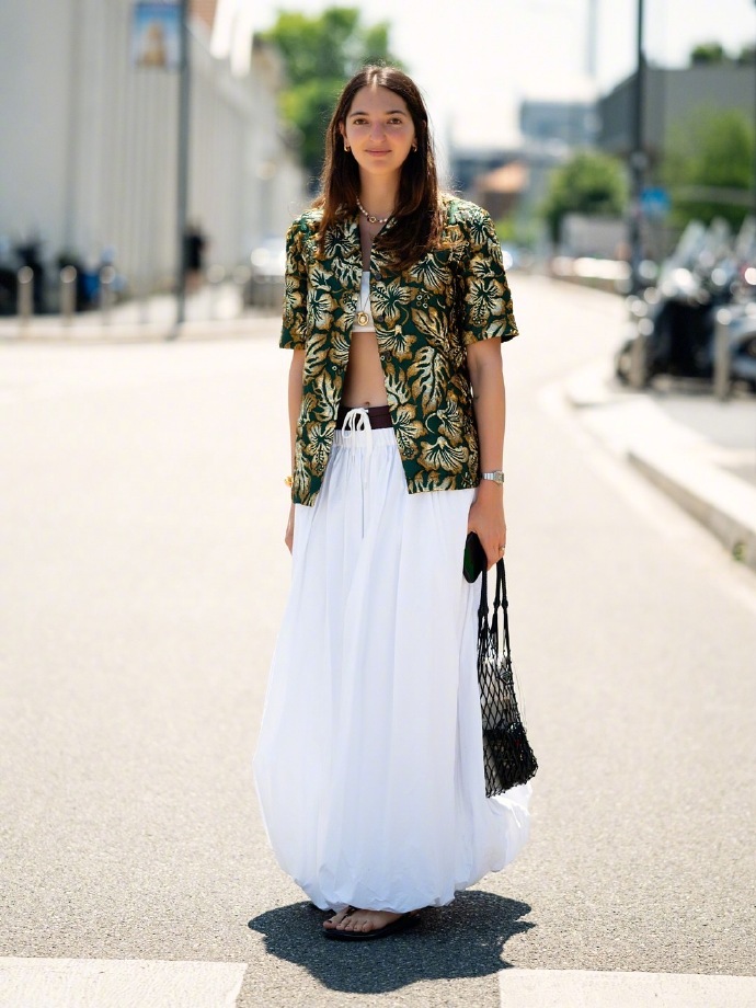 Marta Oldrini in Prada short-sleeve shirt paired with Miu Miu maxi skirt