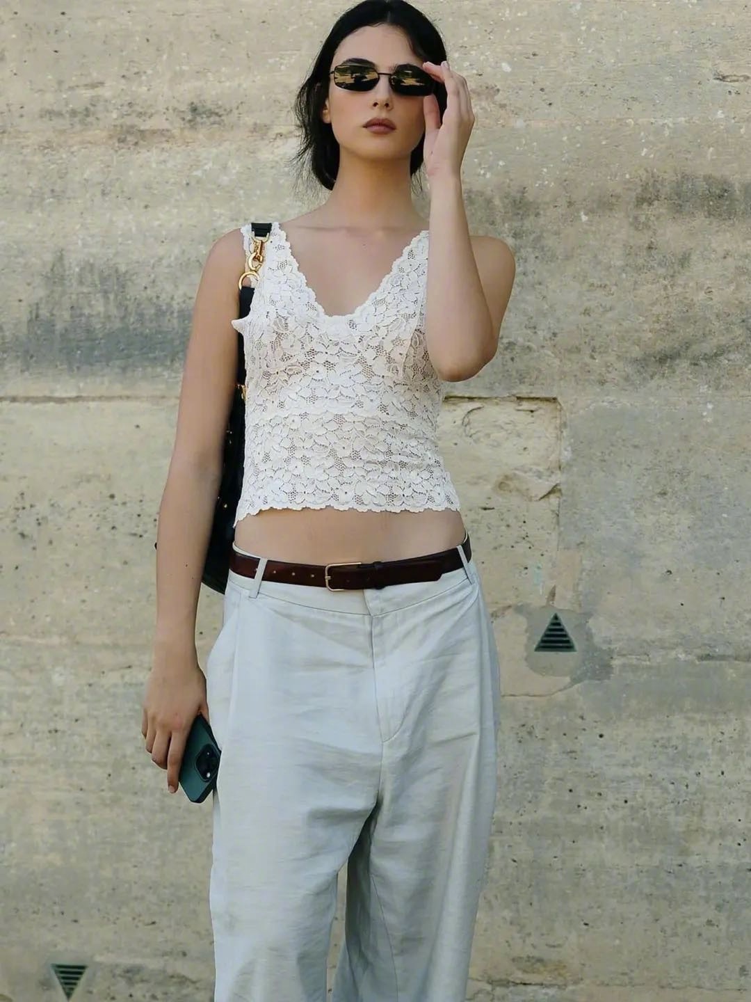 Deva Cassel in lace crop top and high-waisted trousers