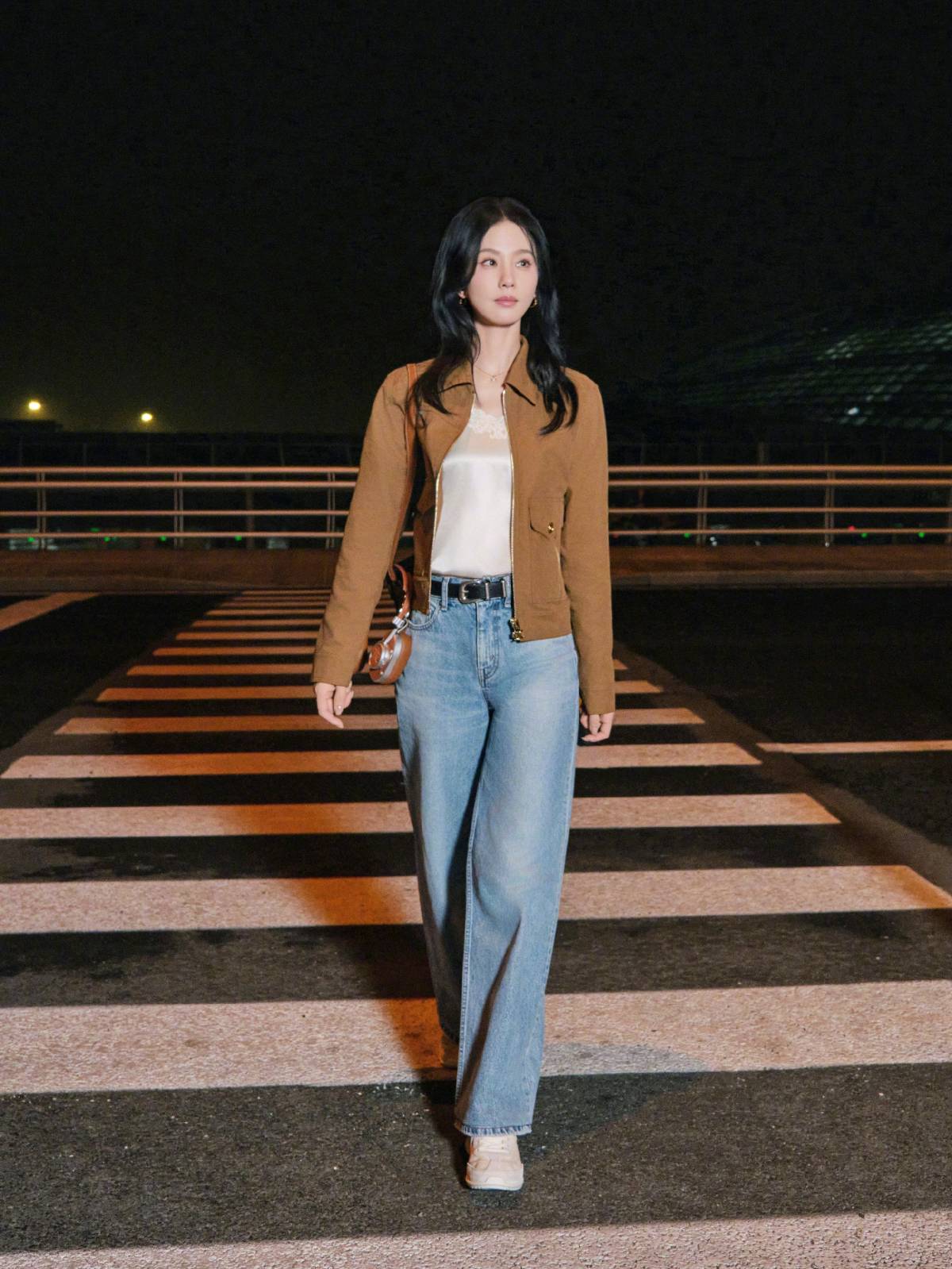 Liu Shishi in brown jacket over a white lace top