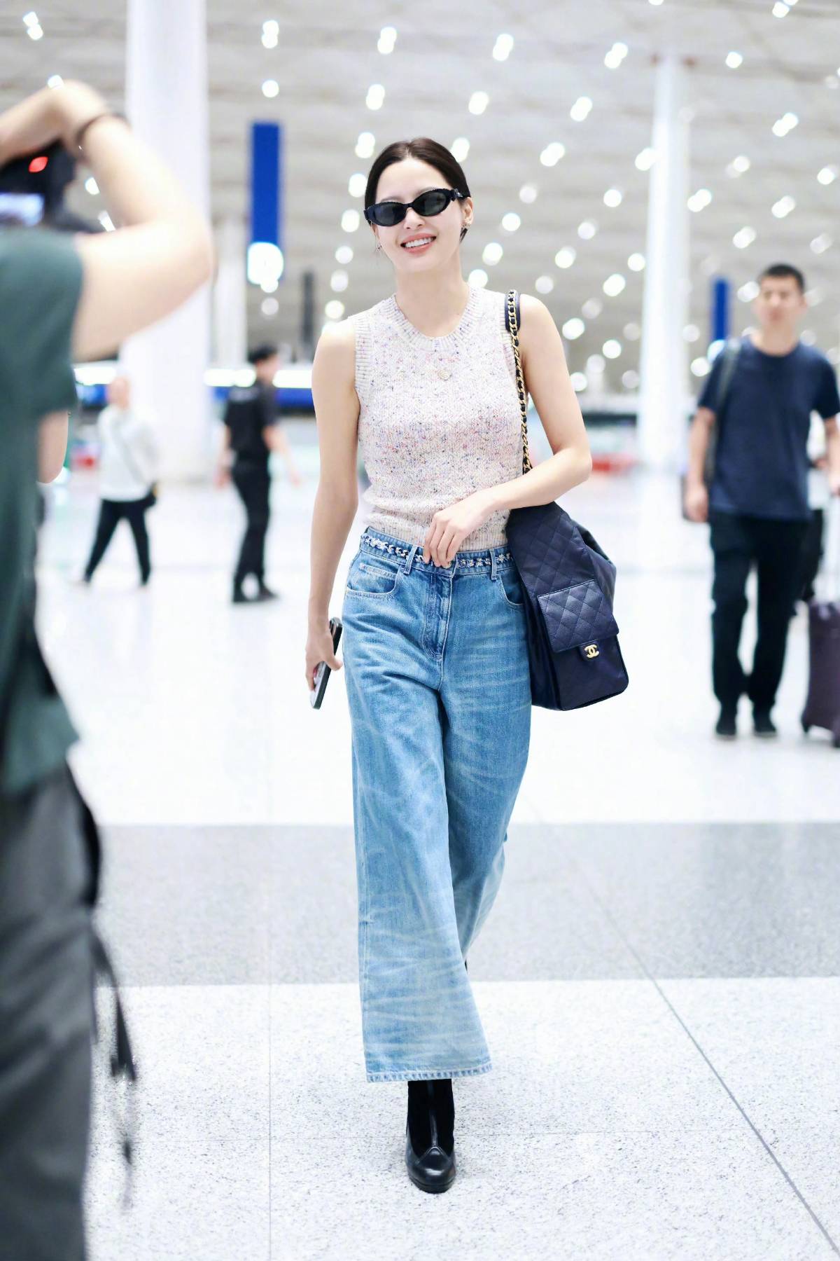 Xin Zhilei wears a CHANEL 2025 Early Fall Haute Couture collection knitted vest and jeans