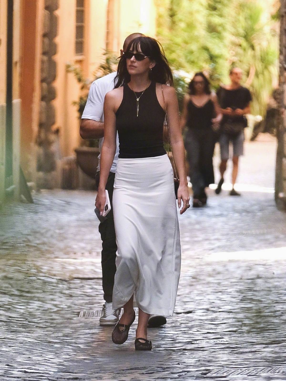 Dakota Johnson wore a black sleeveless tank top with a white Leset skirt.