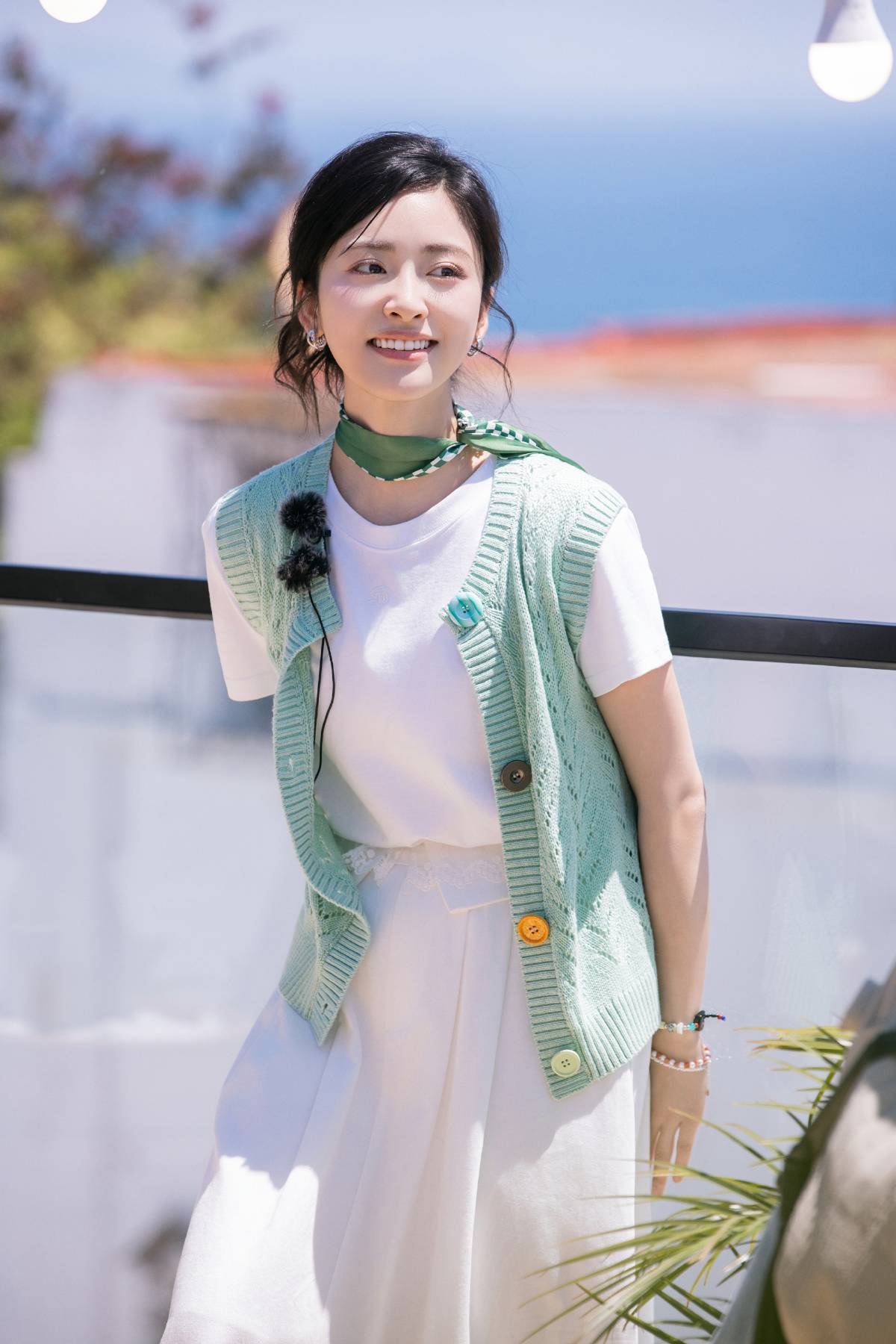 Youthful and cute outfit:  white skirt and white t-shirt paired with knit vest