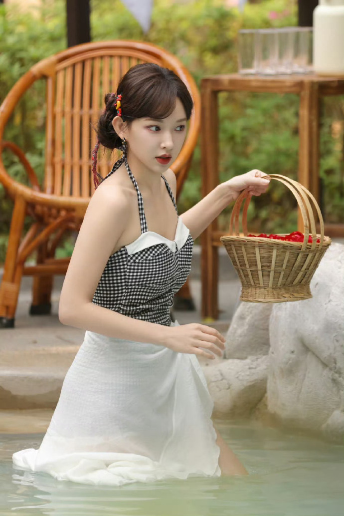 Cheng Xiao wears a plaid strappy swimsuit paired with a white sarong.