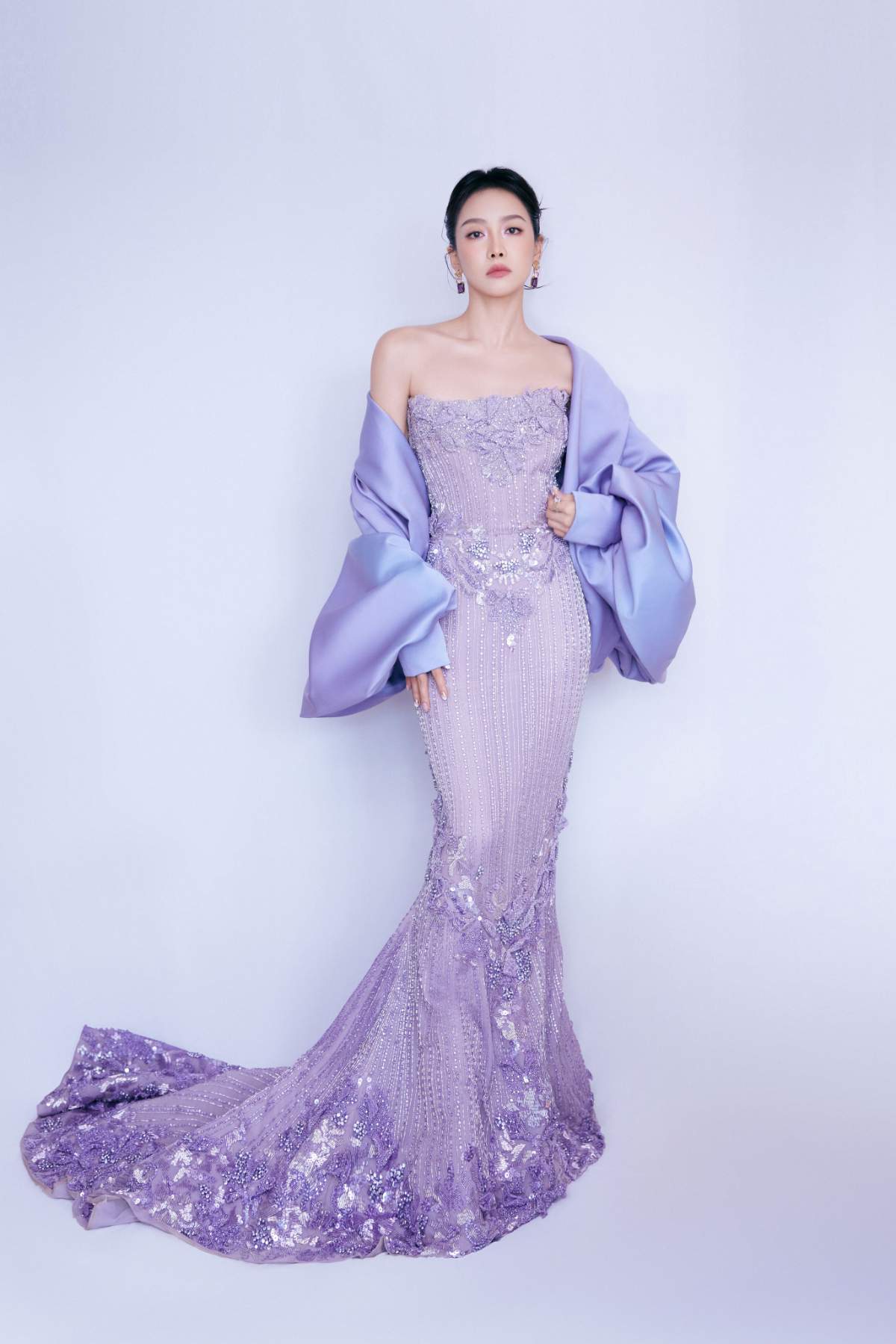 An elegant purple strapless mermaid-style evening gown