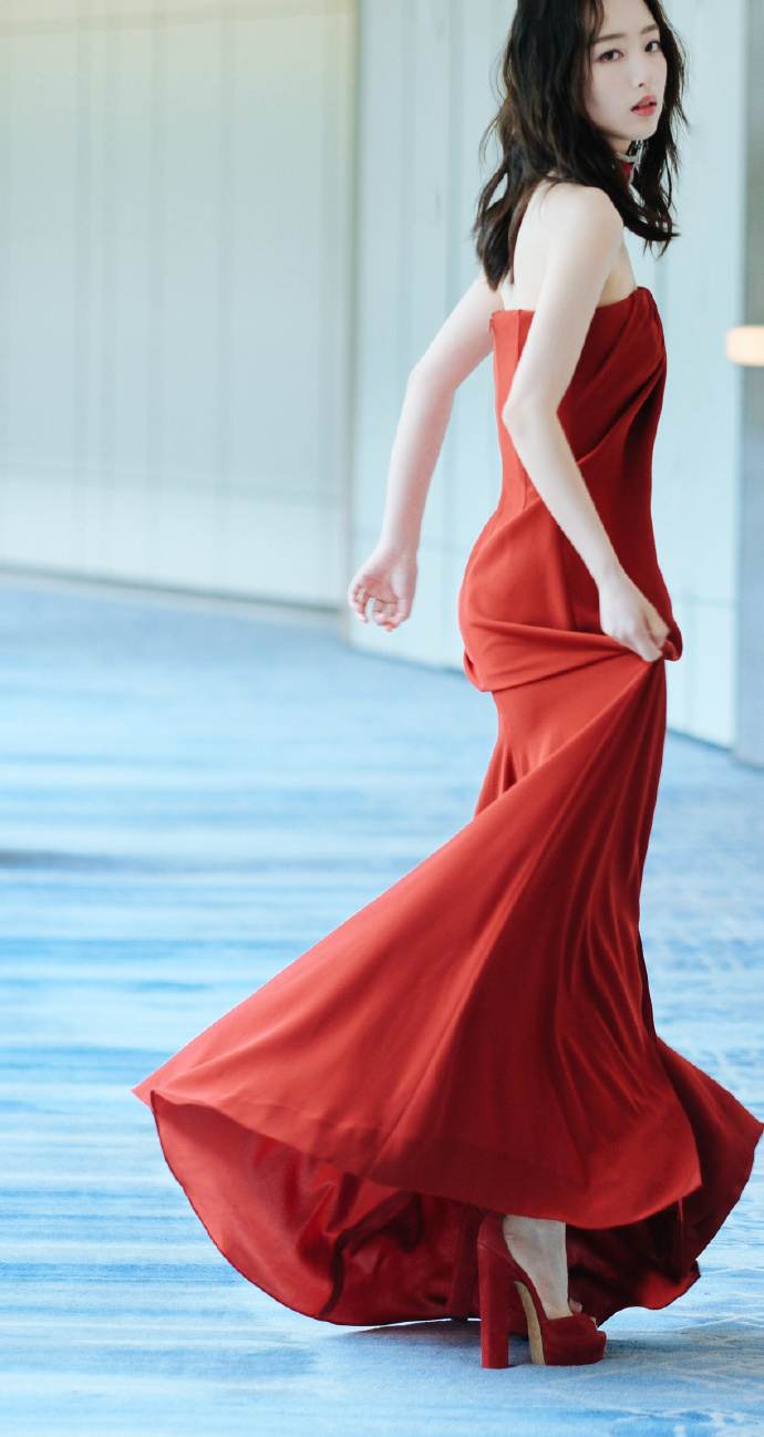 Red strapless gown with matching red high heels.