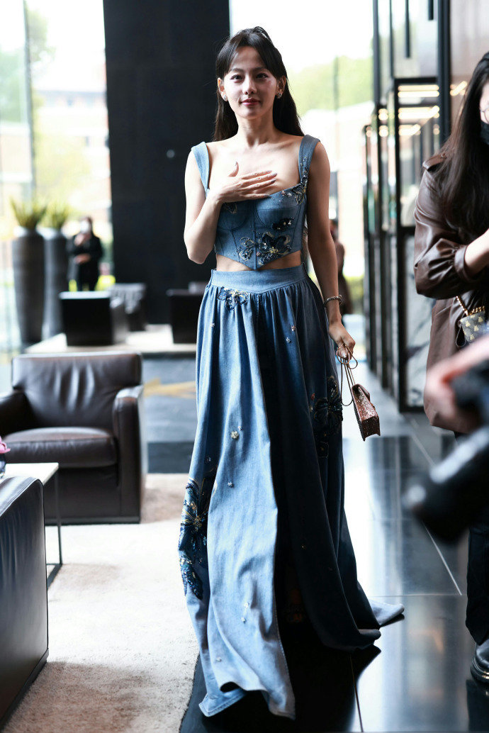 The star wore a blue suit with cropped top and long skirt to attend the Bulgari event