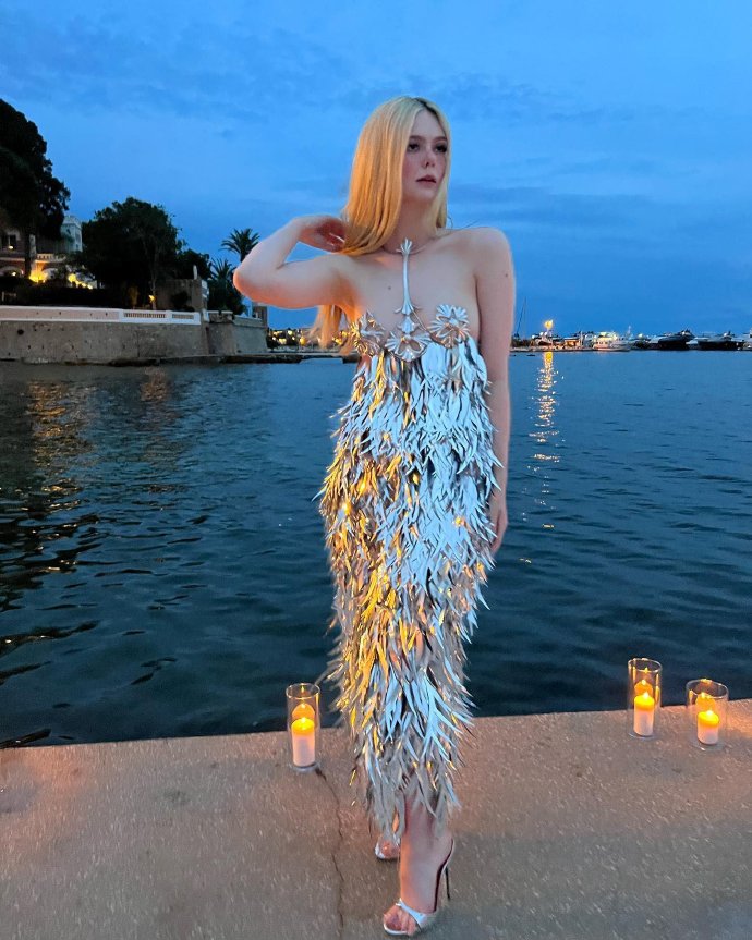 Elle Fanning in a silver metallic sequin outfit.