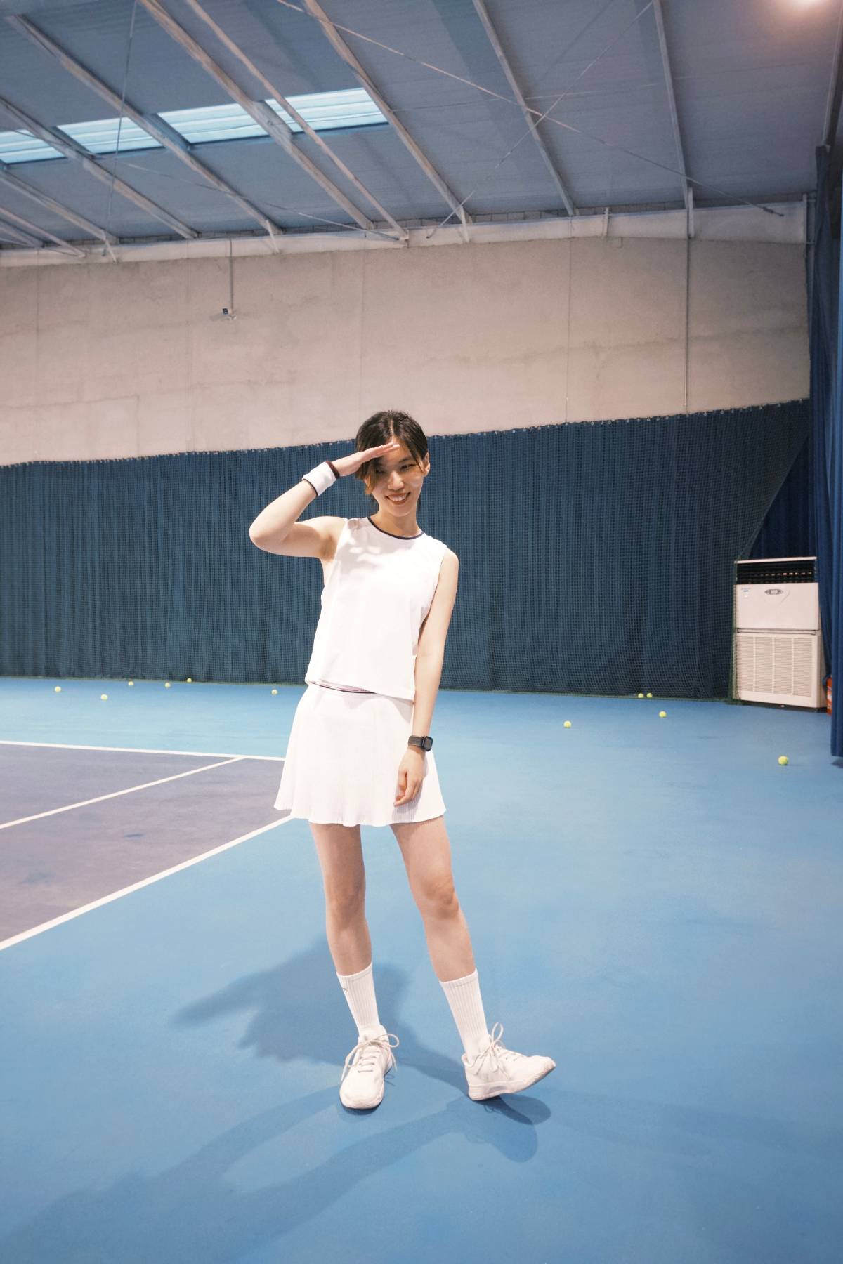 White tennis outfit combo: White tank top, white tennis skirt, white sneakers & white sports socks