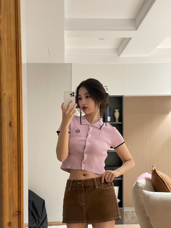 Pink cropped cardigan paired with mini skirt