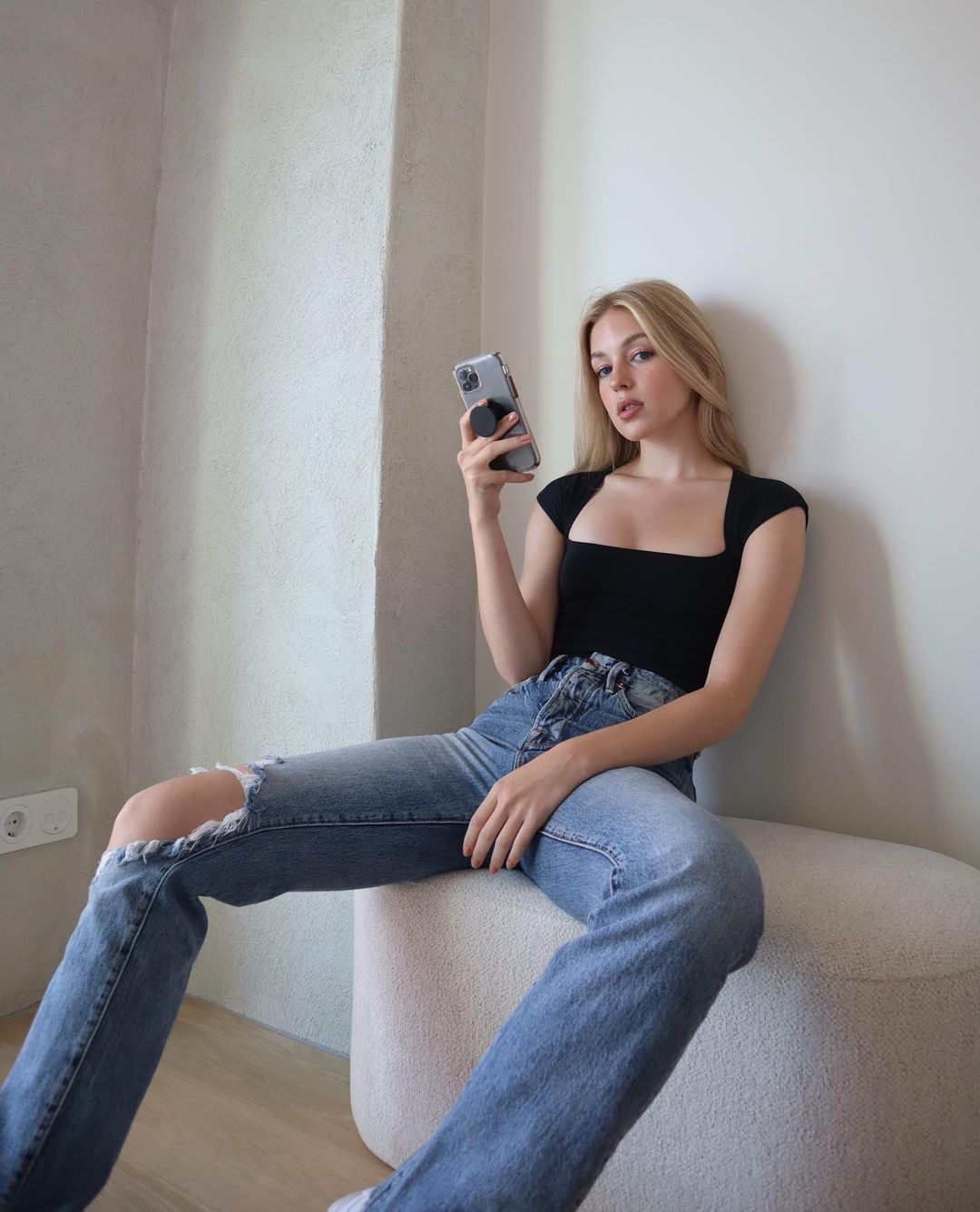 Gabby Thomas. Fitted top & ripped jeans combination