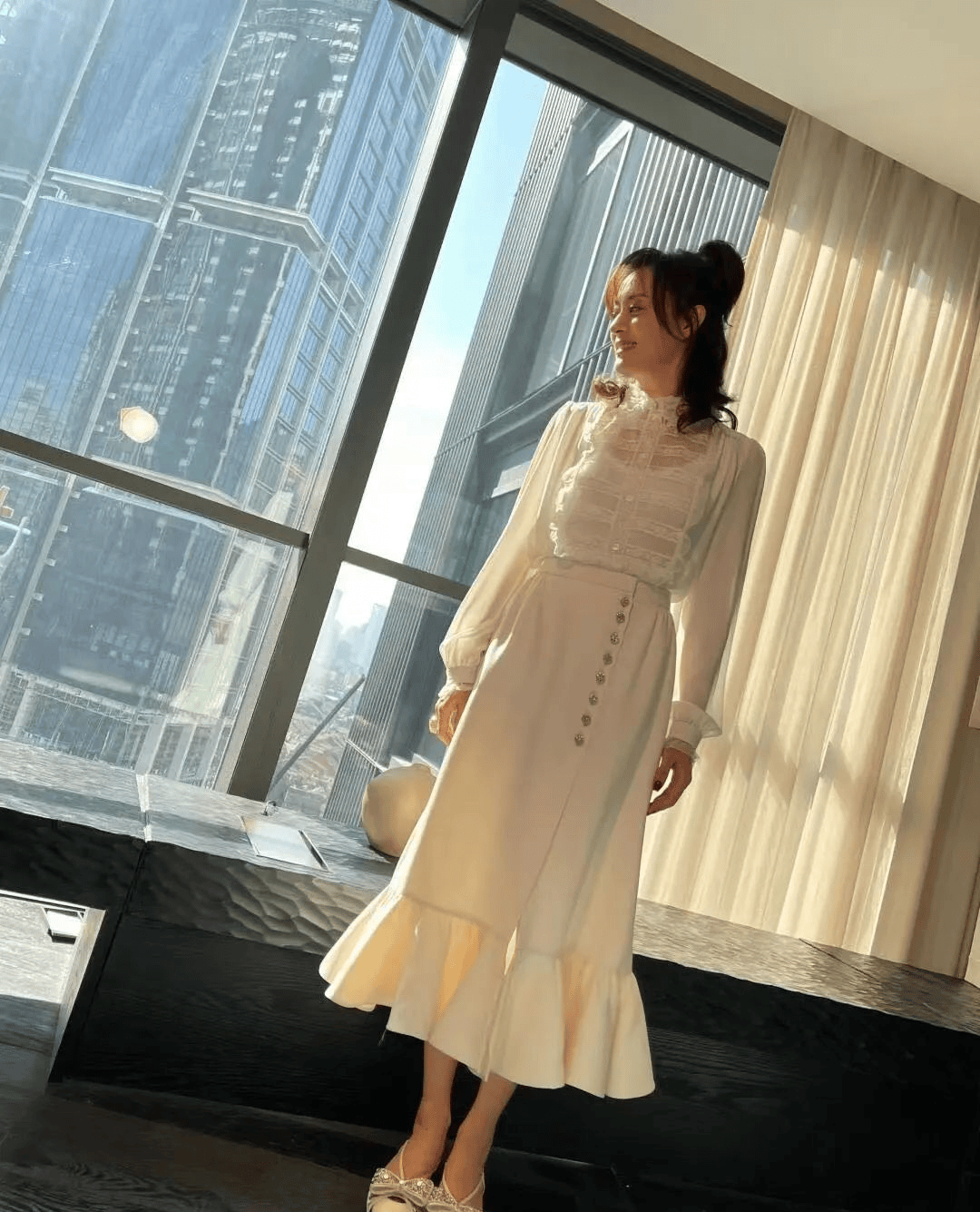 Elegant sheer blouse paired with midi skirt