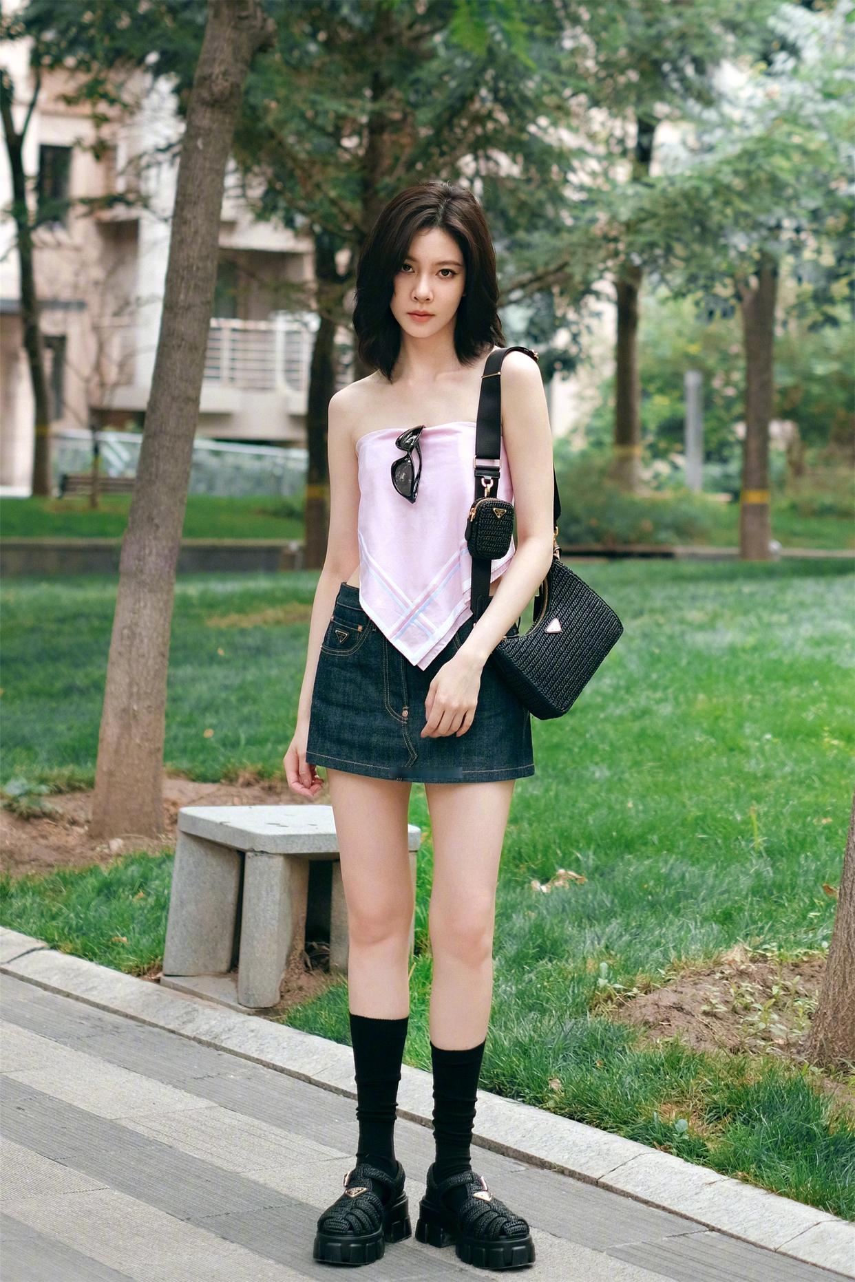 A pink scarf top paired with denim mini skirt