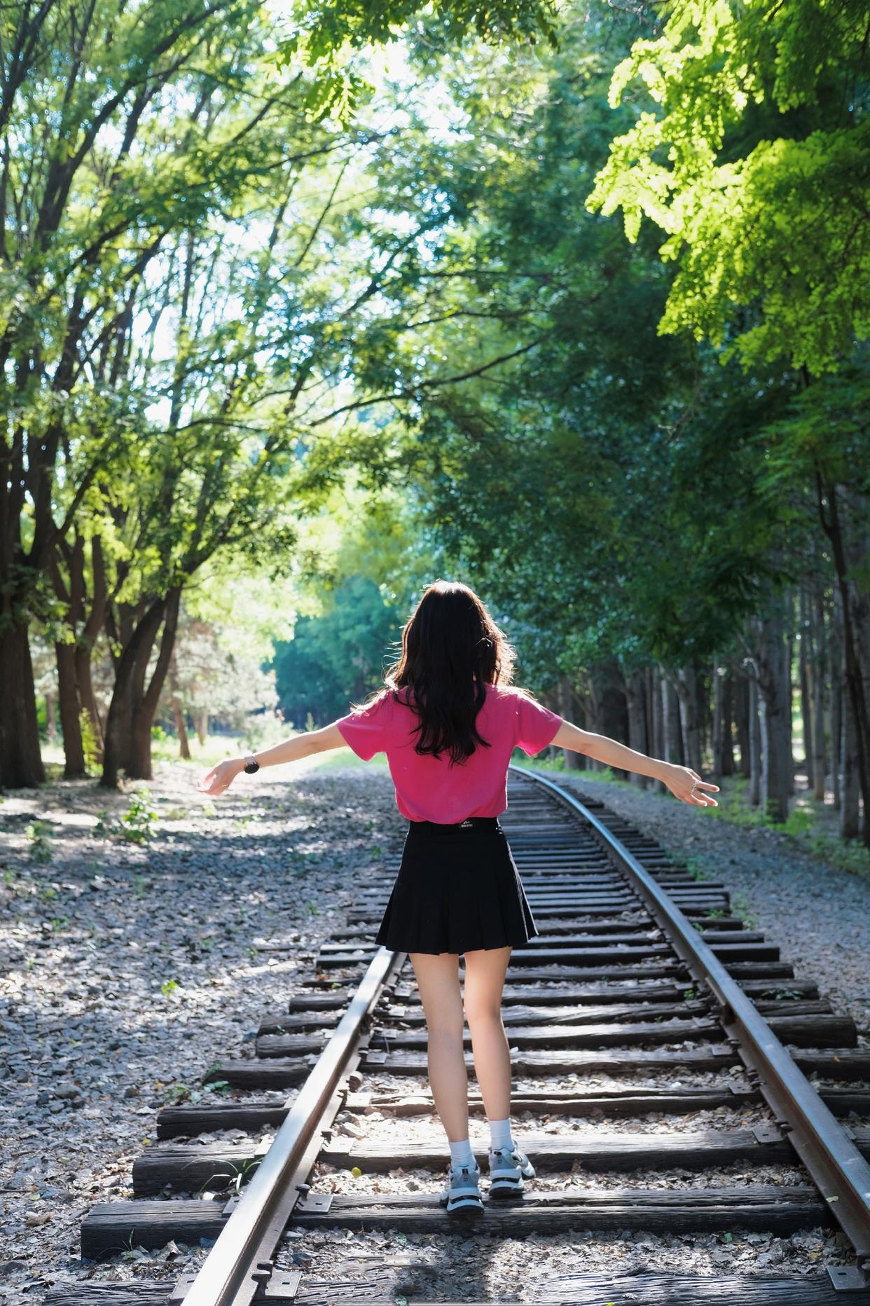 Youthful and fresh in a pink tee and black mini skirt.