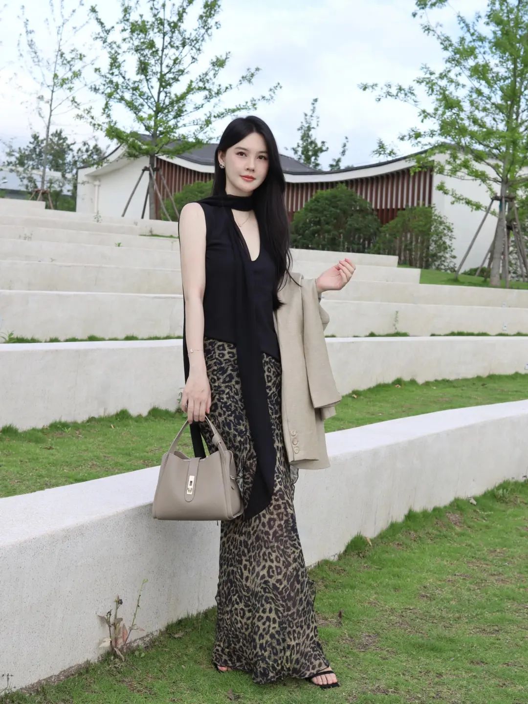Elegant sleeveless top paired with leopard print skirt