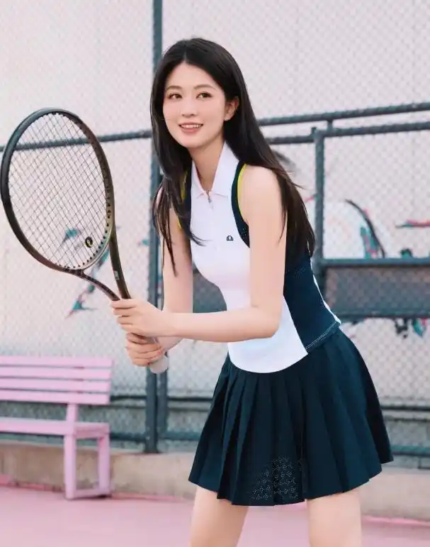 Blue and white polo shirt with a blue pleated tennis skirt, full of youthful energy.