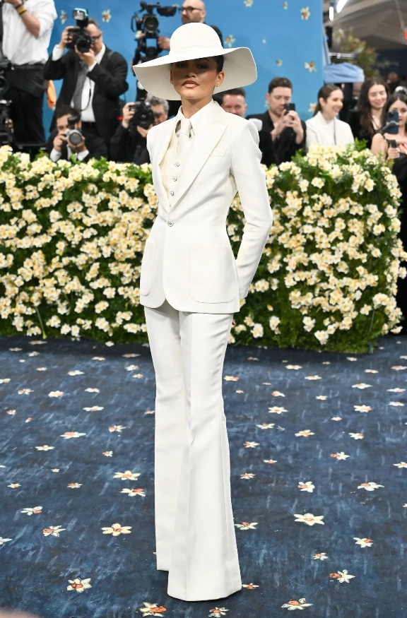 Zendaya in a white suit and matching hat look.