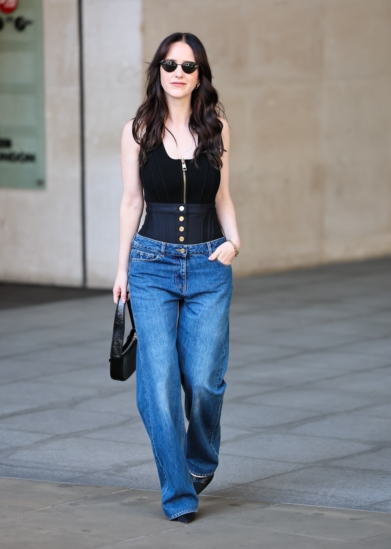 Rachel Brosnahan in elegant corset top paired with wide-leg jeans