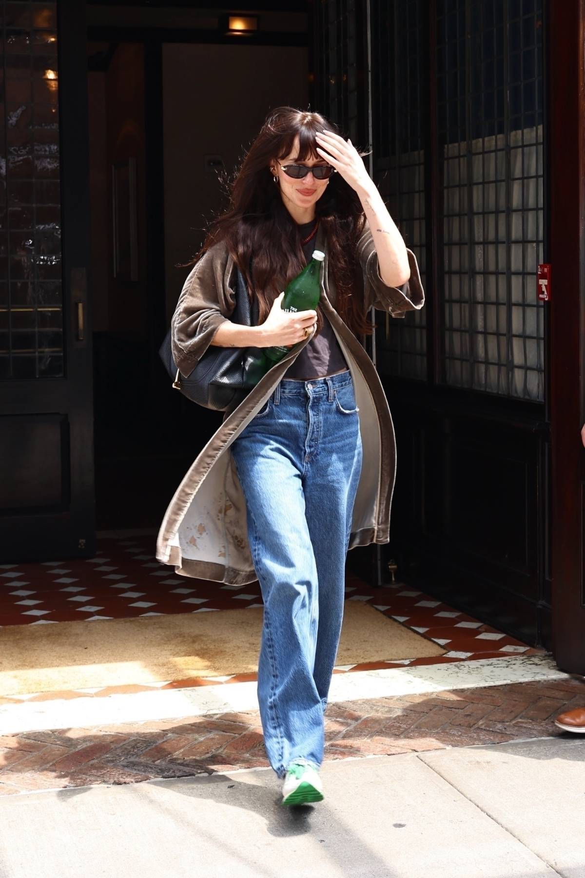 Dakota Johnson in trench coat and jeans