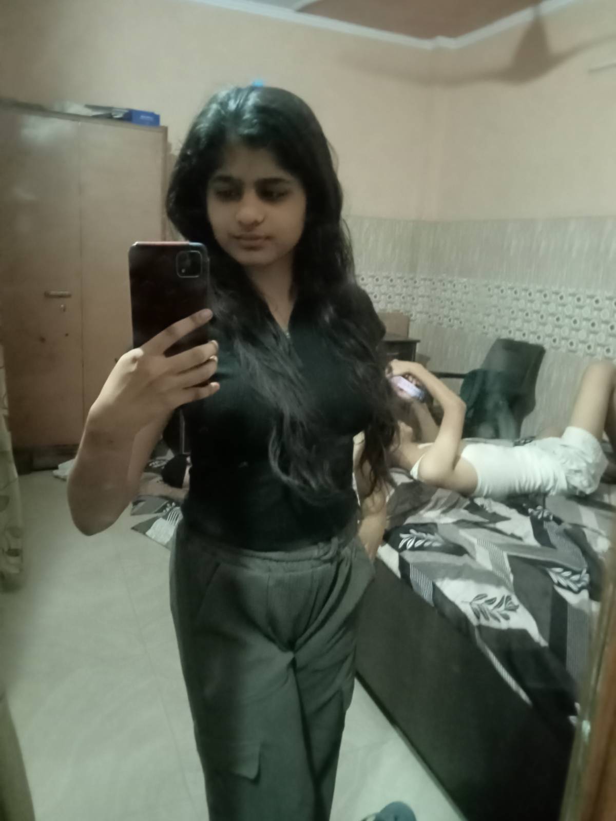 Elegant black top paired with high-waisted pants