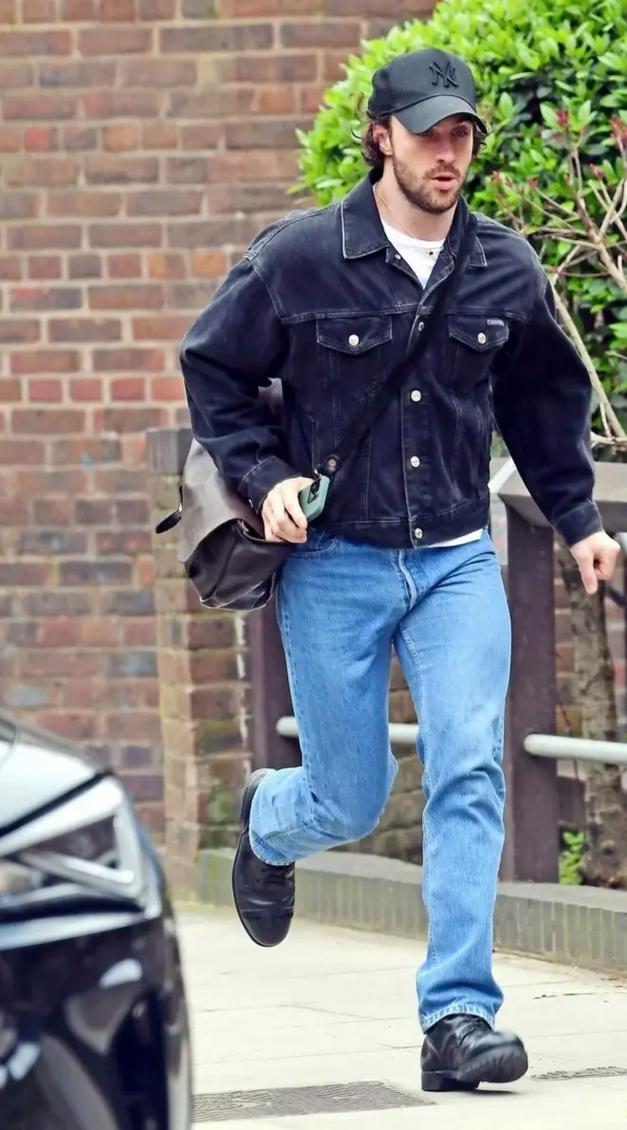 man, black cap, denim jacket, jeans, leather shoes, leather bag