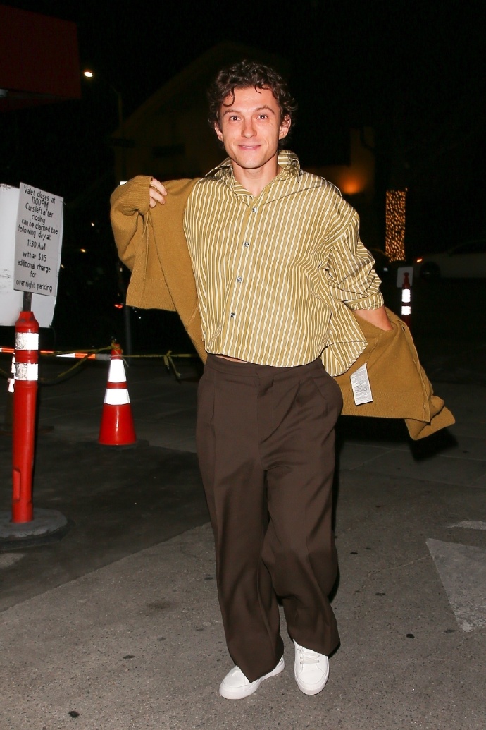 Tom Holland in a striped shirt and trousers