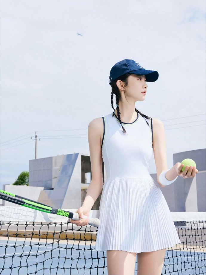 Elegant tennis dress paired with cap