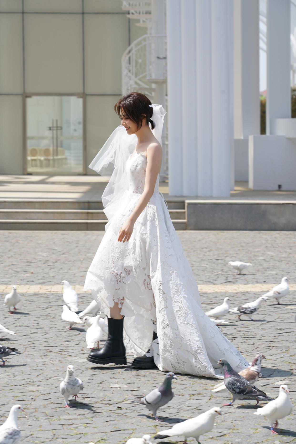 White lace wedding dress paired with combat boots