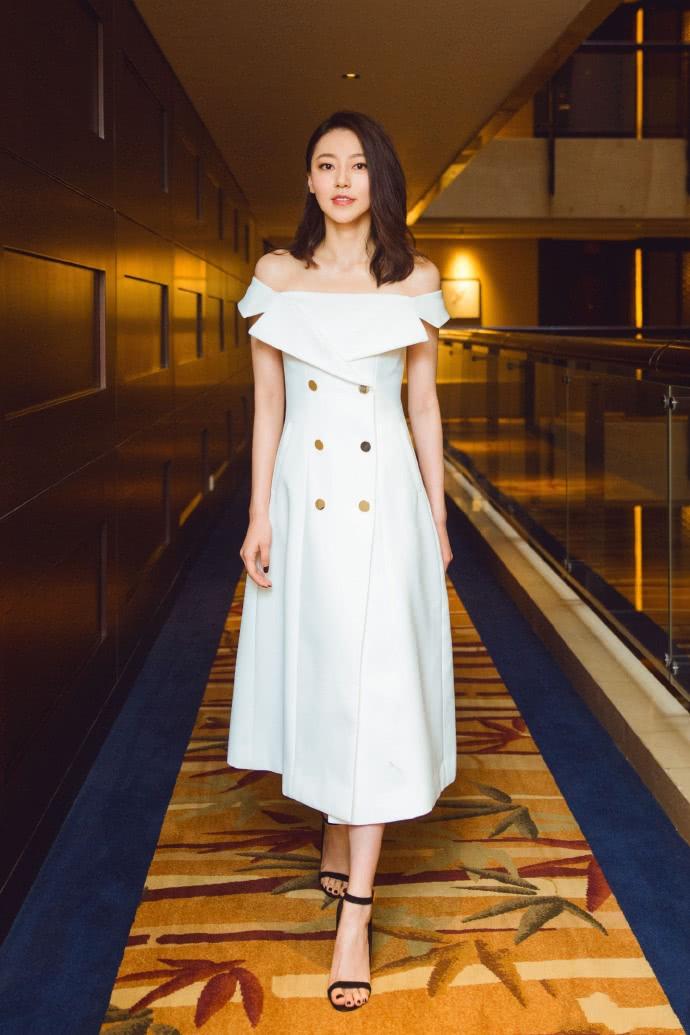 Elegant off-the-shoulder dress paired with strappy heels
