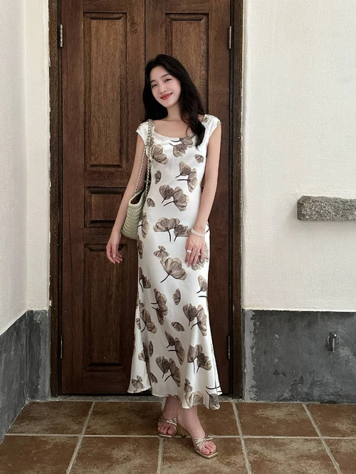 Elegant Cream Maxi Dress with Earthy Floral Patterns and Summery Accessories