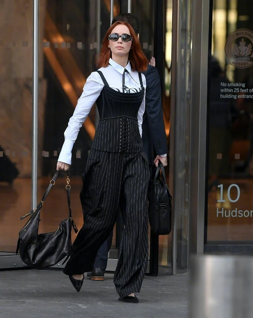 Emily Blunt appeared on the set of *The Devil Wears Prada 2* in a sophisticated black and white pinstripe outfit.
