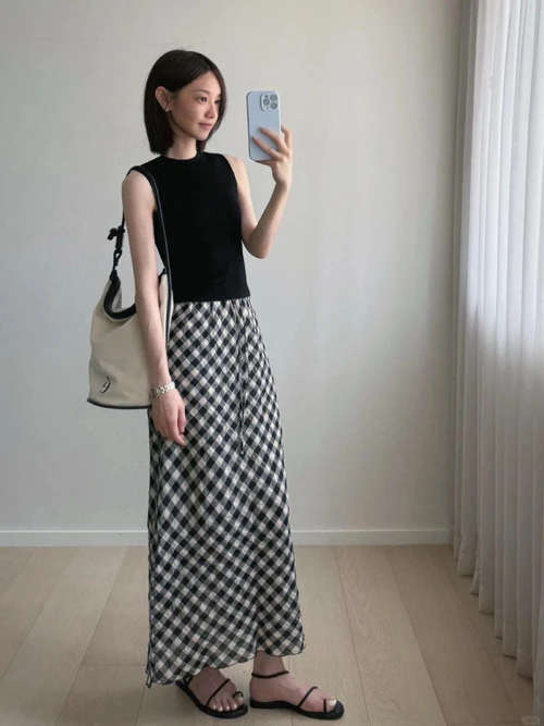 Chic Black Top with Checkered Maxi Skirt and Sandals for Effortless Elegance