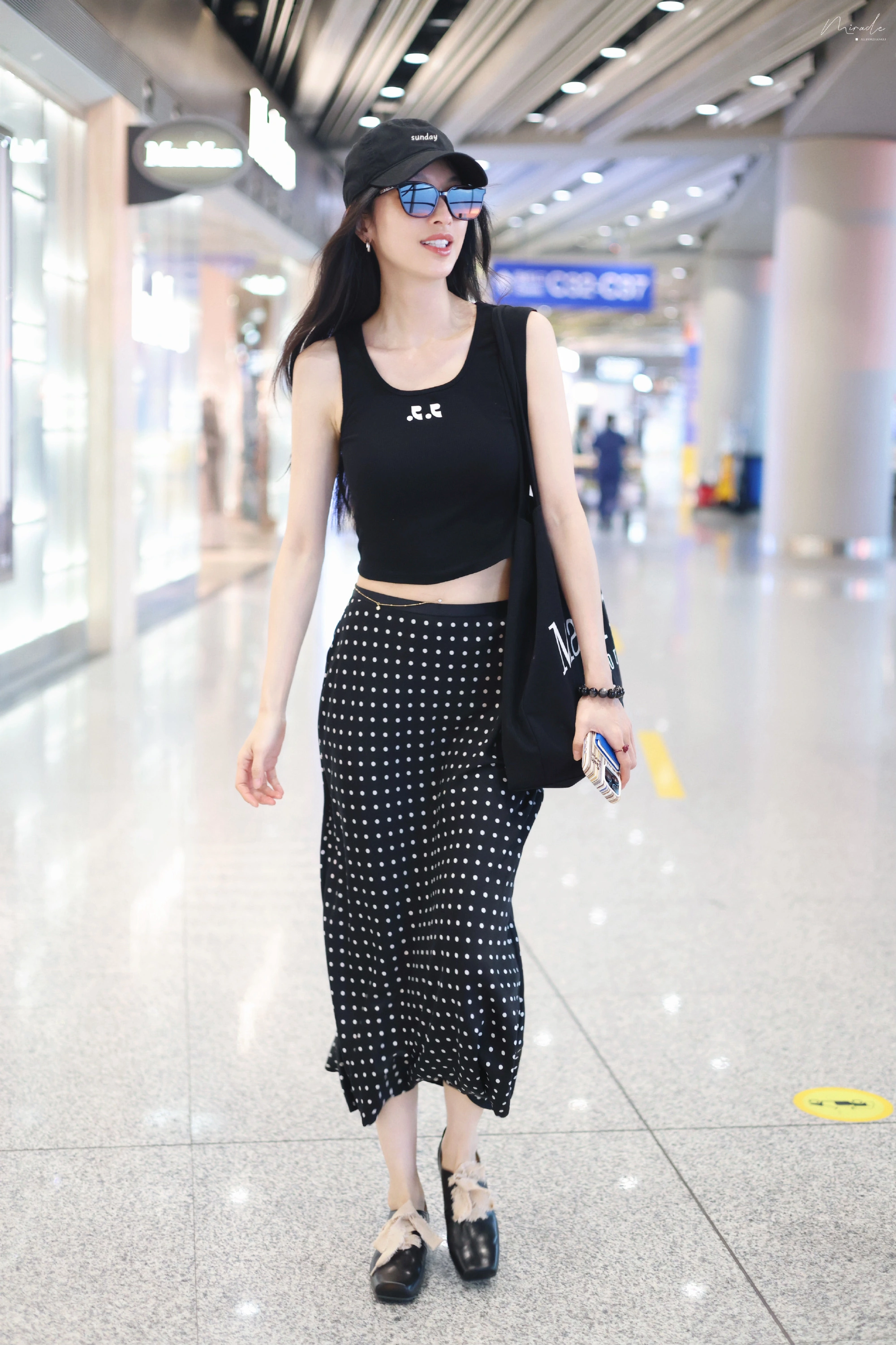 Urban Chic: Black Crop Top and Polka Dot Skirt with Modern Accessories