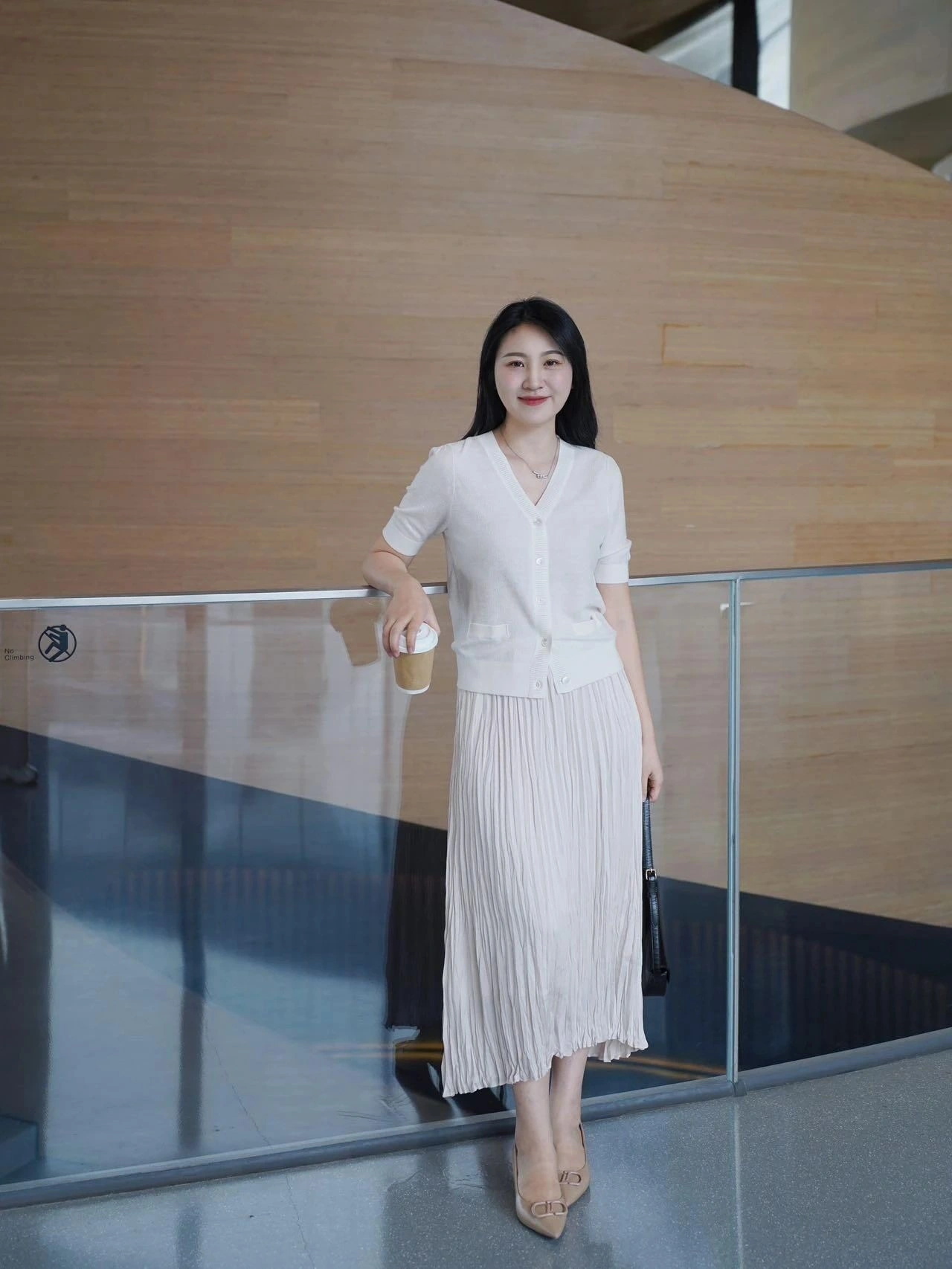 Elegant Monochrome Ensemble with Cream Cardigan and Pleated Midi Skirt