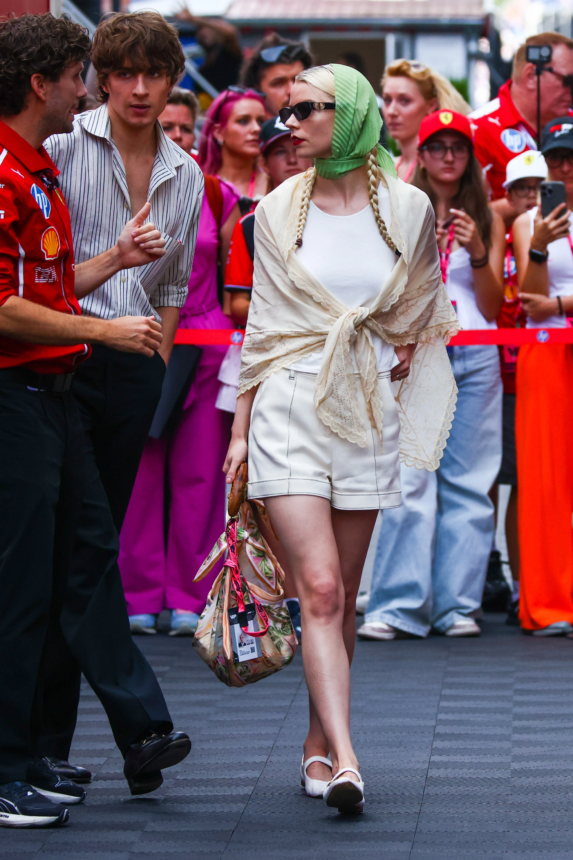 Chic Summer Ensemble with Tailored Shorts and Lace Shawl Accentuated by Vibrant Accessories