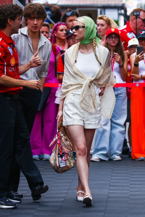 Chic Summer Ensemble with Tailored Shorts and Lace Shawl Accentuated by Vibrant Accessories