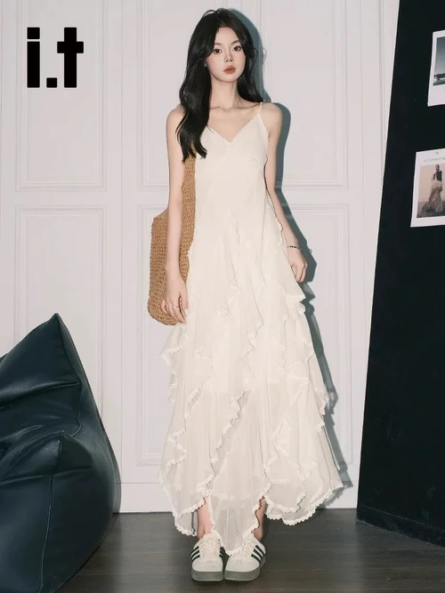 Romantic White Maxi Dress with Ruffles and Sporty Sneakers for a Modern Twist