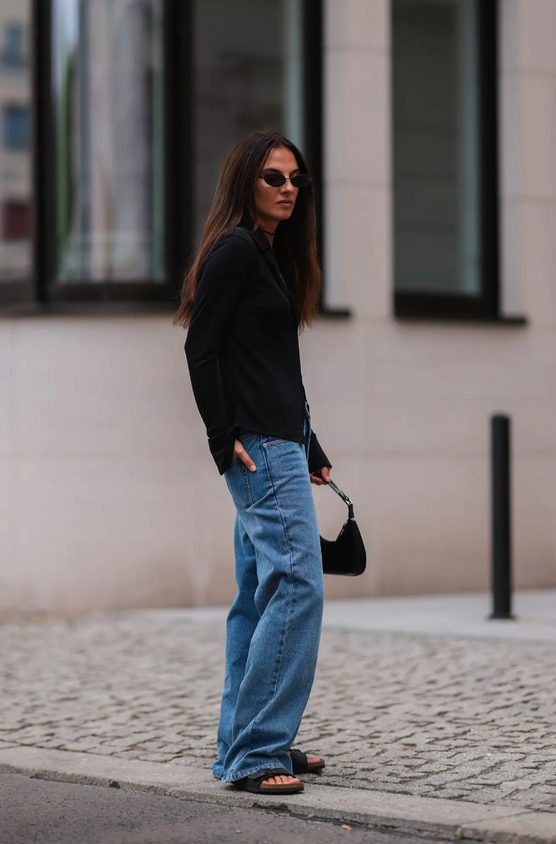 Casual Cool or Retro Relic? Wide-Leg Jeans with a Black Top and Compact Handbag
