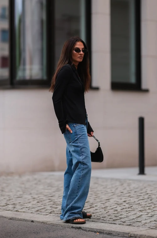 Casual Cool or Retro Relic? Wide-Leg Jeans with a Black Top and Compact Handbag