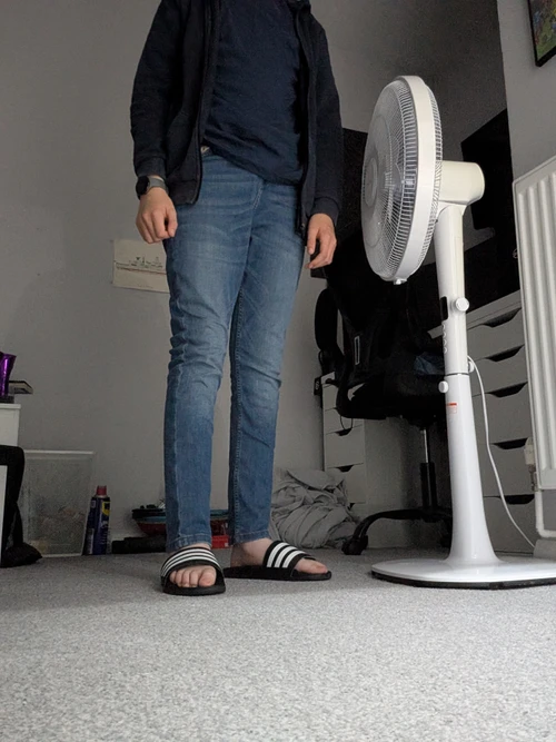 Casual Blue Jeans and Hoodie Outfit with Striped Slides for a Relaxed Look